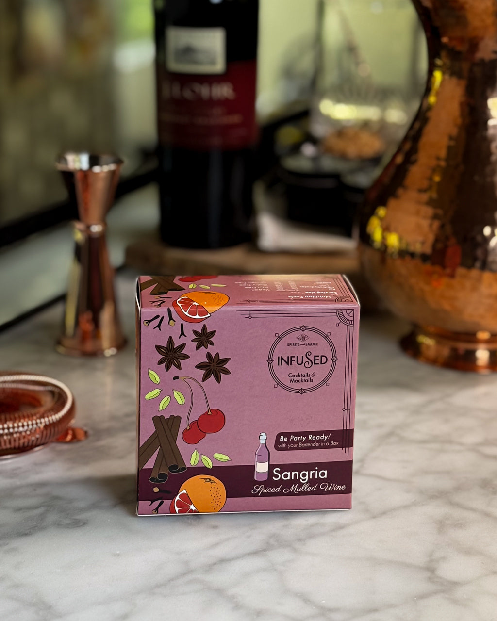 Box of 'Infused Sangria' wine on a marble surface with blurred background