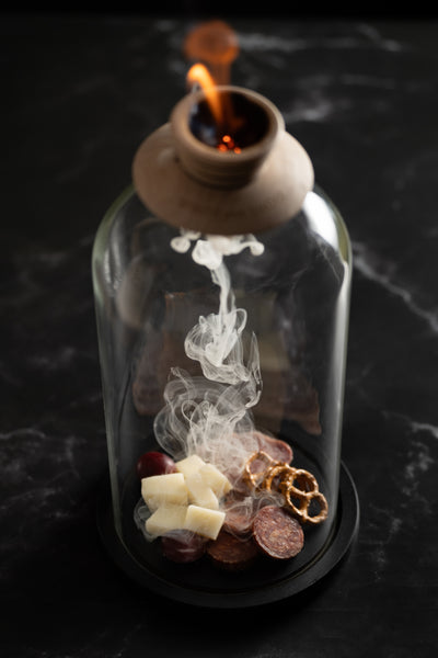 smoking charcuterie in a glass dome and smoker top